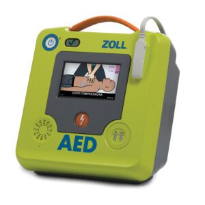 ZOLL AED 3 Defibrillator mit Farbdisplay, das die Herzdruckmassage visuell anleitet, grünes Gehäuse mit Tragegriff und angeschlossenen Elektroden für die Reanimation